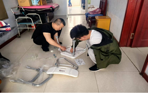 图为工作人员到残疾人家里进行坐便椅安装调试